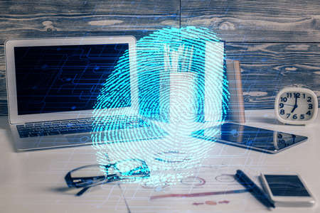 Computer on desktop in office with finger print drawing. Double exposure. Concept of business data...