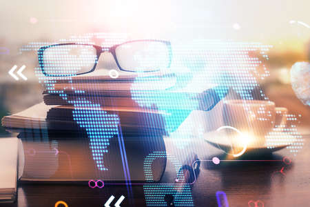 Map hologram with glasses on the table background. Concept of globalization. Double exposure.