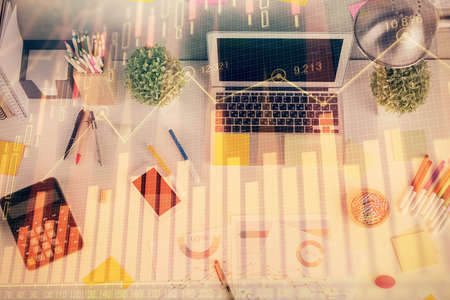 Double exposure of forex chart drawing over table background with computer. Concept of financial research and analysis. Top view.の写真素材