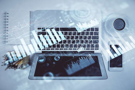Stock market chart and top view computer on the table background. Multi exposure. Concept of...