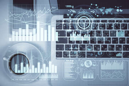Stock market chart and top view computer on the table background. Multi exposure. Concept of...
