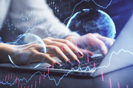 Double exposure of businesswoman hands typing on computer and forex chart hologram drawing. Financial analysis concept.の写真素材