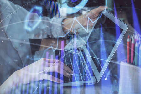 Double exposure of woman hands typing on computer and forex chart hologram drawing. Stock market...