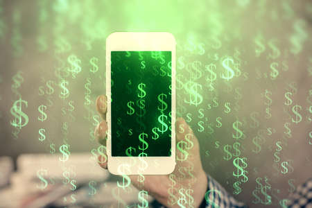 Double exposure of mans hands holding and using a digital device and forex graph drawing. Financial...