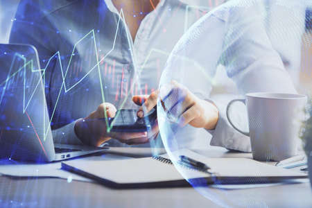 Double exposure of forex chart sketch hologram and woman holding and using a mobile device....