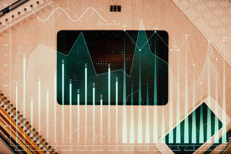 Double exposure of forex graph hologram over desktop with phone. Top view. Mobile trade platform...