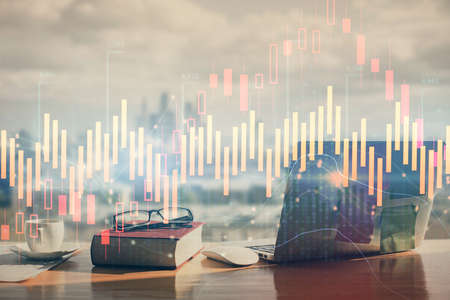 Double exposure of financial chart drawings and desk with open notebook background. Concept of forex...