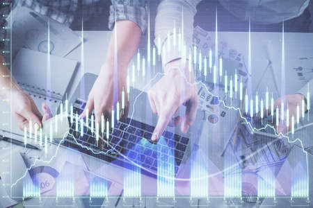 Double exposure of man and woman working together and forex graph hologram drawing. Financial...