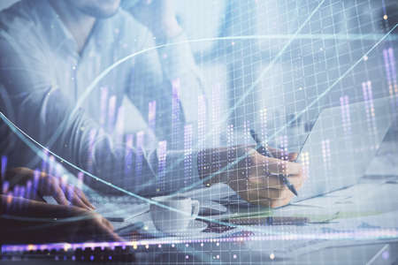 Double exposure of man and woman working together and financial graph hologram. Business concept....