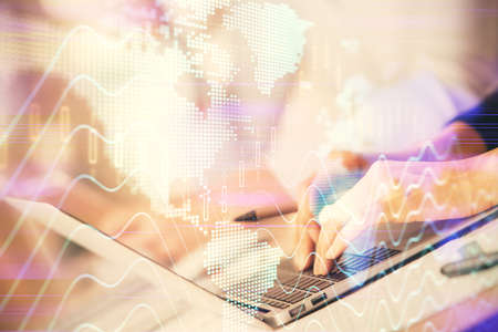 Double exposure of woman hands typing on computer and forex chart hologram drawing. Stock market...