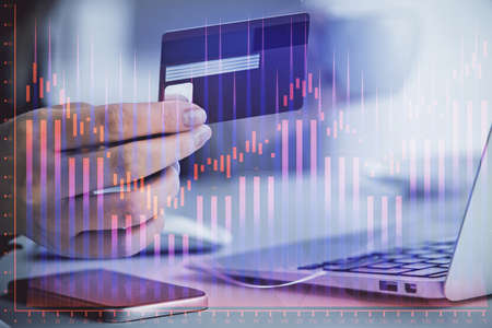 Multi exposure of woman on-line shopping holding a credit card and financial graph drawing. Stock...
