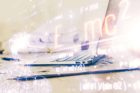 Desktop computer background and formula hologram writing. Double exposure. Education concept.