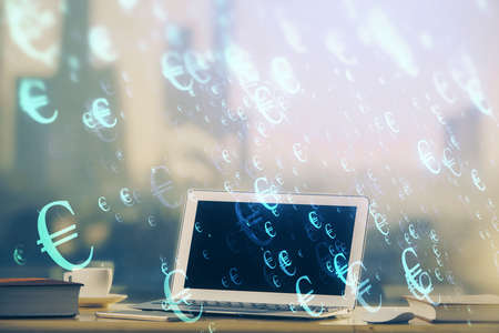 Forex Chart hologram on table with computer background. Multi exposure. Concept of financial markets.の写真素材