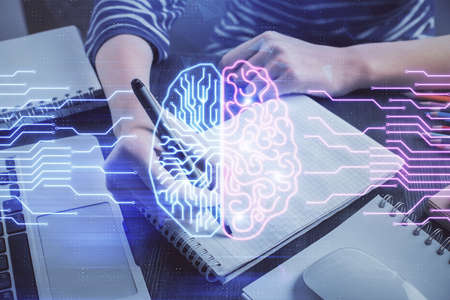Multi exposure of writing hand on background with brain hologram. Concept of self learning.
