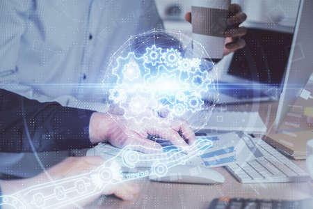 Double exposure of technology hologram with man working on computer background. Concept of big data.