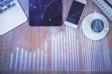 Multi exposure of forex graph hologram over desktop with phone. Top view. Mobile trade platform concept.の写真素材