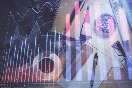 Double exposure of forex graph drawing and work table top veiw. Concept of financial analysis.