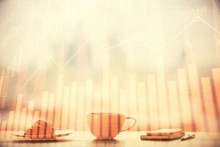 Double exposure of forex chart over coffee cup background in office. Concept of financial analysis...