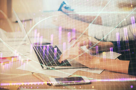 Multi exposure of woman hands typing on computer and financial chart hologram drawing. Stock market analysis concept.の写真素材