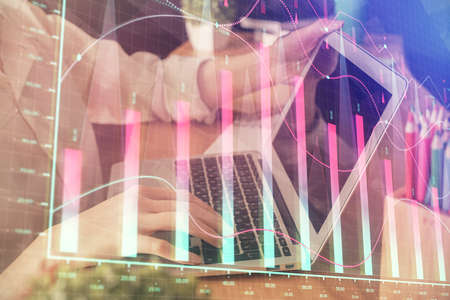 Double exposure of woman hands typing on computer and forex chart hologram drawing. Stock market...