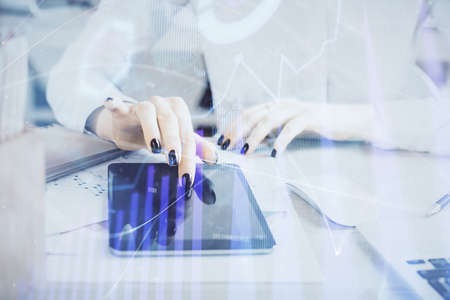 Double exposure of forex chart sketch hologram and woman holding and using a mobile device. Financial market concept.の写真素材