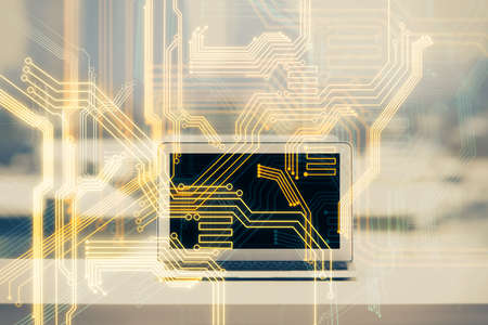 Computer on desktop in office with technology theme hologram. Double exposure. Tech concept.