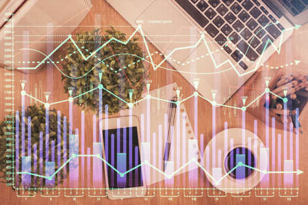 Multi exposure of financial chart hologram over desktop with phone. Top view. Mobile trade platform concept.の写真素材