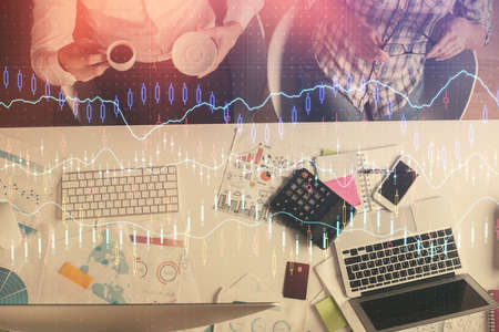 Double exposure of man and woman working together and financial chart hologram drawing. market...