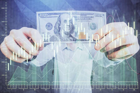 Multi exposure of financial graph drawing hologram and USA dollars bills and man hands. Analysis concept.の写真素材