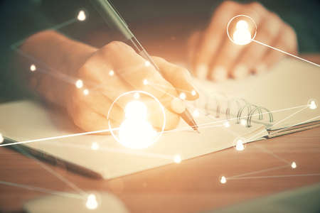 Social network theme hologram over womans hands writing background. Concept of international people connect. Double exposureの写真素材