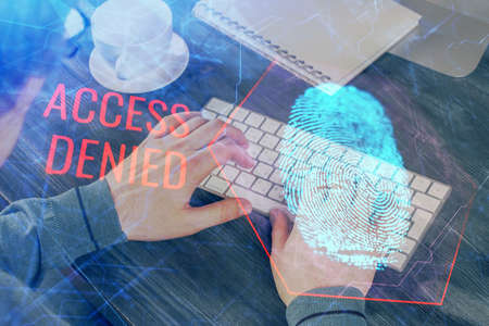 Fingerprint hologram with businessman working on computer on background. Security concept. Double exposure.の写真素材