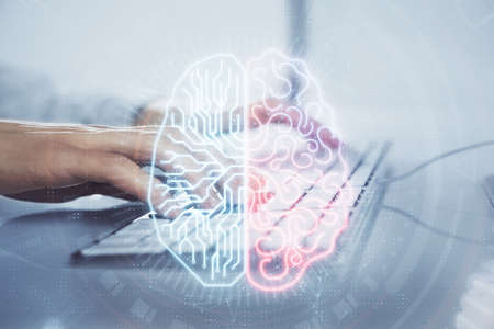 Businessman with computer background with brain theme hologram. Concept of brainstorm. Multi...