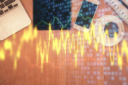 Double exposure of financial chart hologram over desktop with phone. Top view. Mobile trade platform...