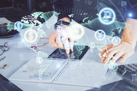 Double exposure of mans hands holding and using a digital device and forex graph drawing. Financial...