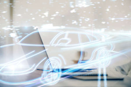 Desktop computer background in office with automobile hologram drawing. Multi exposure. Tech concept.の写真素材