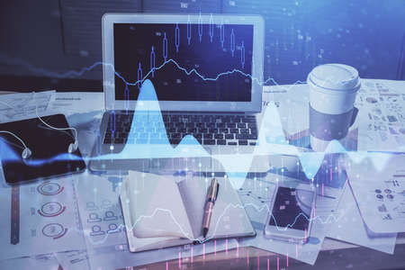 Forex market chart hologram and personal computer background. Multi exposure. Concept of investment.