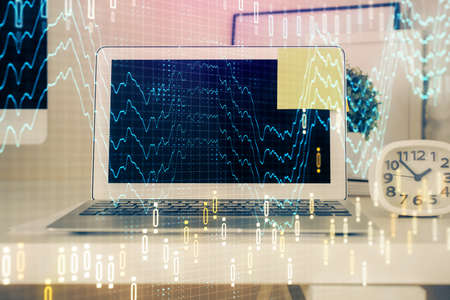 Forex market graph hologram and personal computer on background. Double exposure. Concept of...