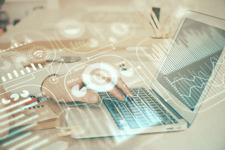 Technology theme hologram with man working on computer on background. High tech concept. Double...