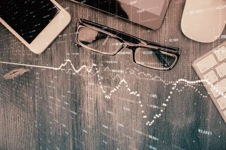 Multi exposure of forex graph hologram over desktop with phone. Top view. Mobile trade platform concept.の写真素材