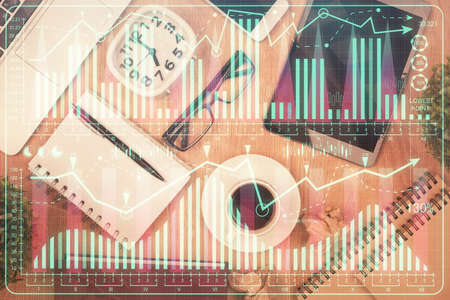 Double exposure of financial chart hologram over desktop with phone. Top view. Mobile trade platform concept.の写真素材