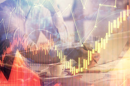Multi exposure of man and woman working together and financial chart hologram. Business concept. Computer background.の写真素材