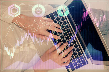 Double exposure of woman hands working on computer and forex chart hologram drawing. Top View....