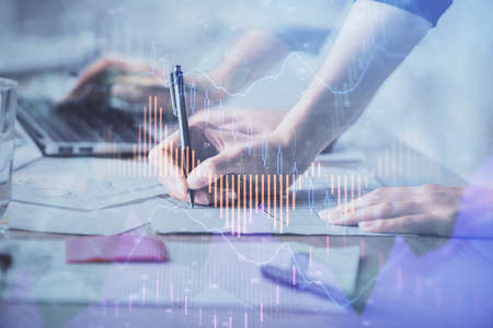 Multi exposure of woman hands typing on computer and financial chart hologram drawing. Stock market...