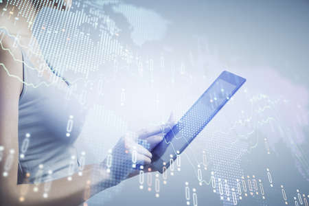 Double exposure of forex chart sketch hologram and woman holding and using a mobile device....