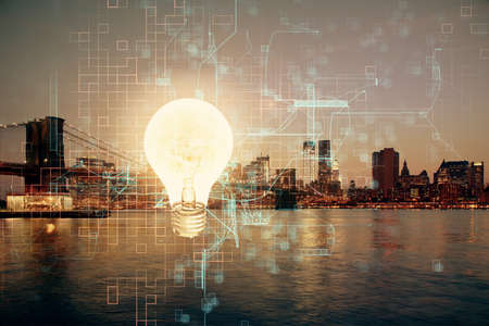 Multi exposure of bulb hologram drawing and cityscape background. Concept of idea.