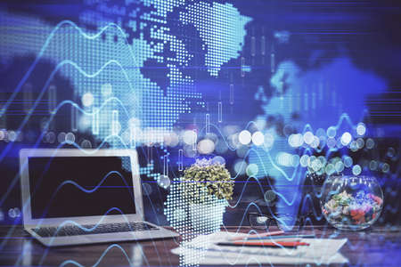 Financial chart drawing and table with computer on background. Double exposure. Concept of...