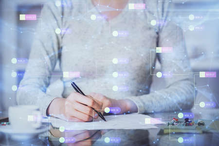 Double exposure of writing hand on background with data solution technology hologram. Ai concept.の写真素材