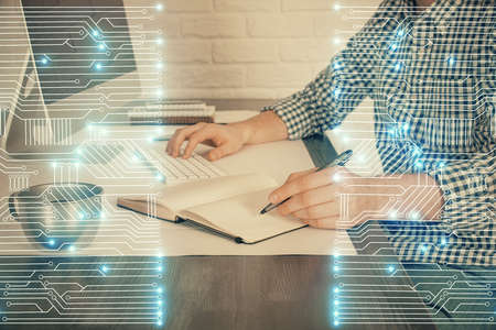 Technology theme hologram with man working on computer on background. High tech concept. Double...