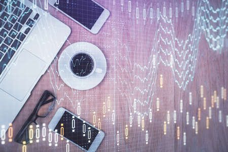 Multi exposure of financial chart hologram over desktop with phone. Top view. Mobile trade platform...
