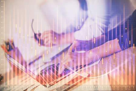Multi exposure of woman hands typing on computer and financial chart hologram drawing. Stock market...